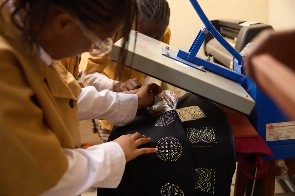 A student ironing in the tailoring room