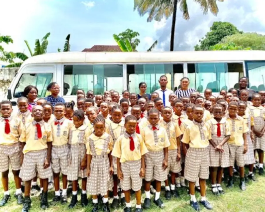 Pupils in front of the school coach before an excursion