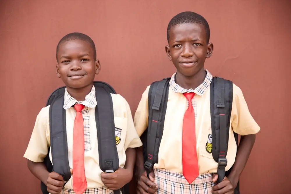 Two primary pupils with their school bags