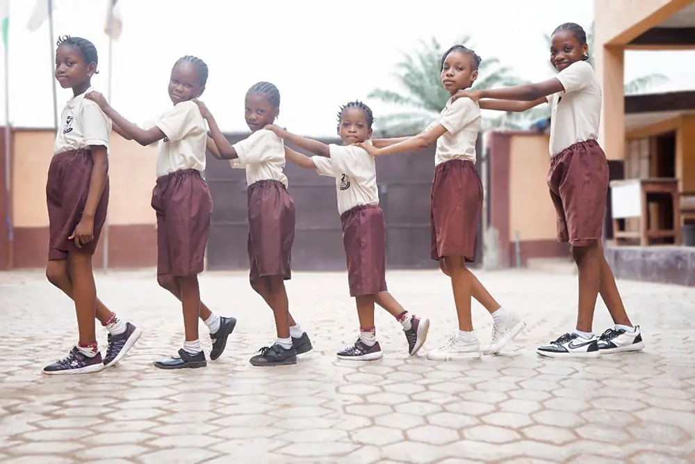 Pupils holding hands in a circle during break