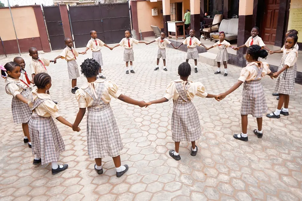 Children playing a ring game in the school yard