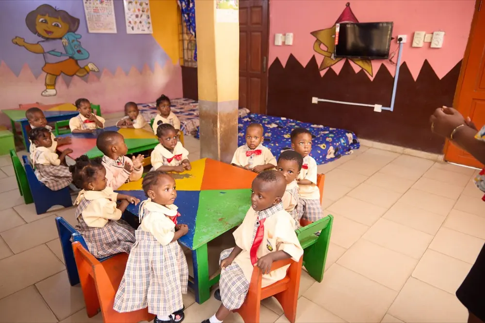 Nursery children playing on the soft-floor area in the Early Years room