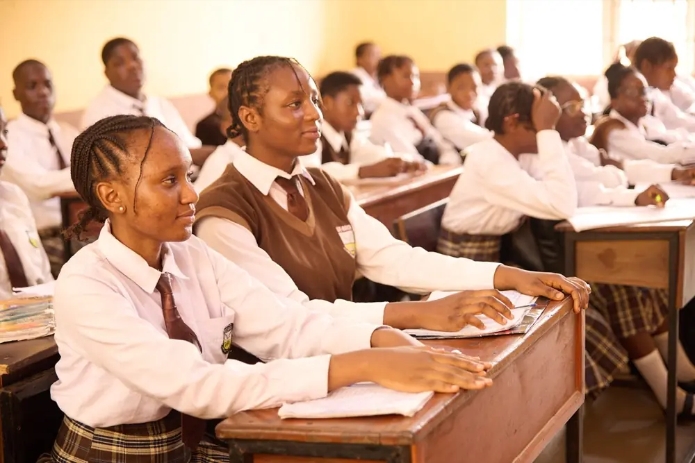 Students raising their hands to answer